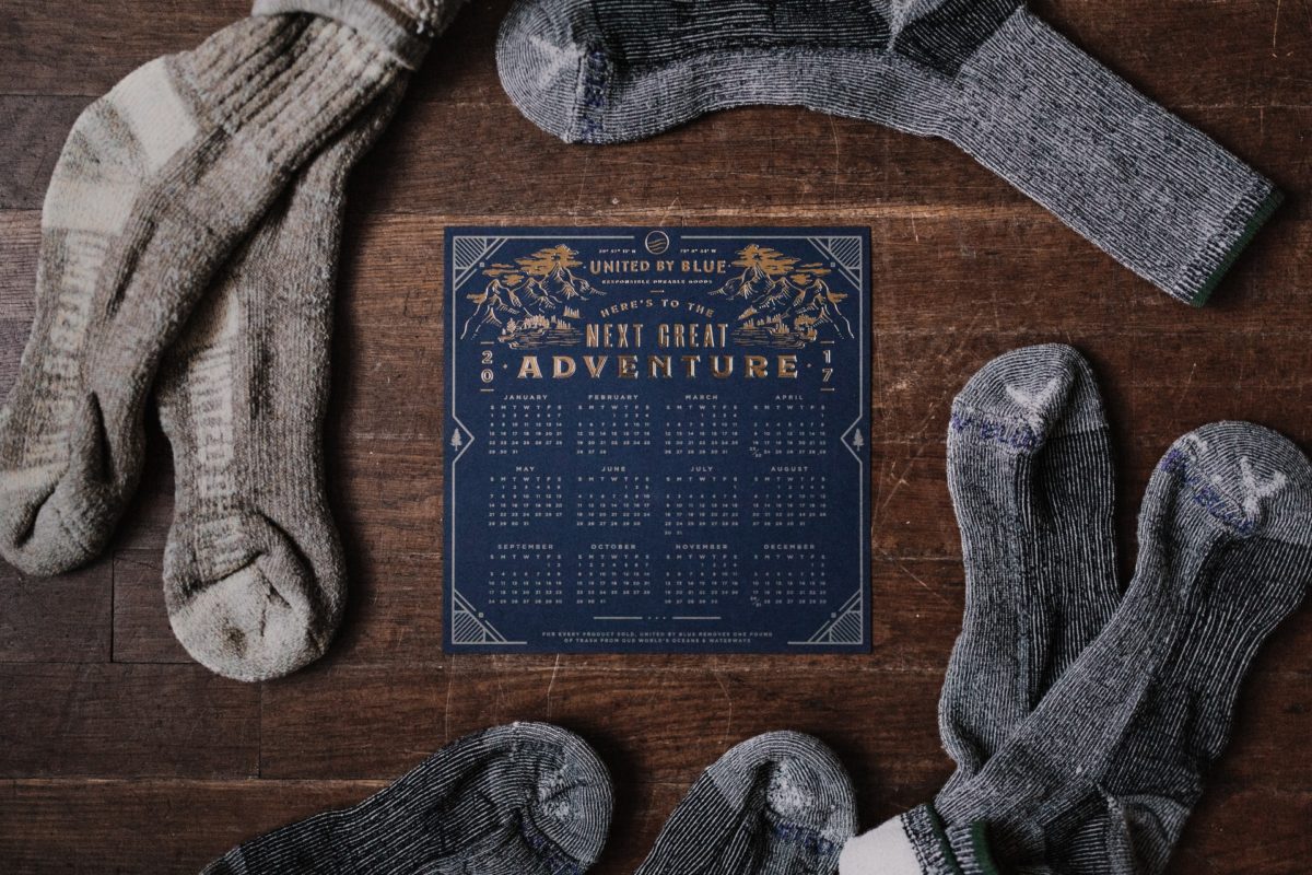 Wool socks and a sign that says 'Next Great Adventure'. Photo by Andrew Neel on Unsplash.